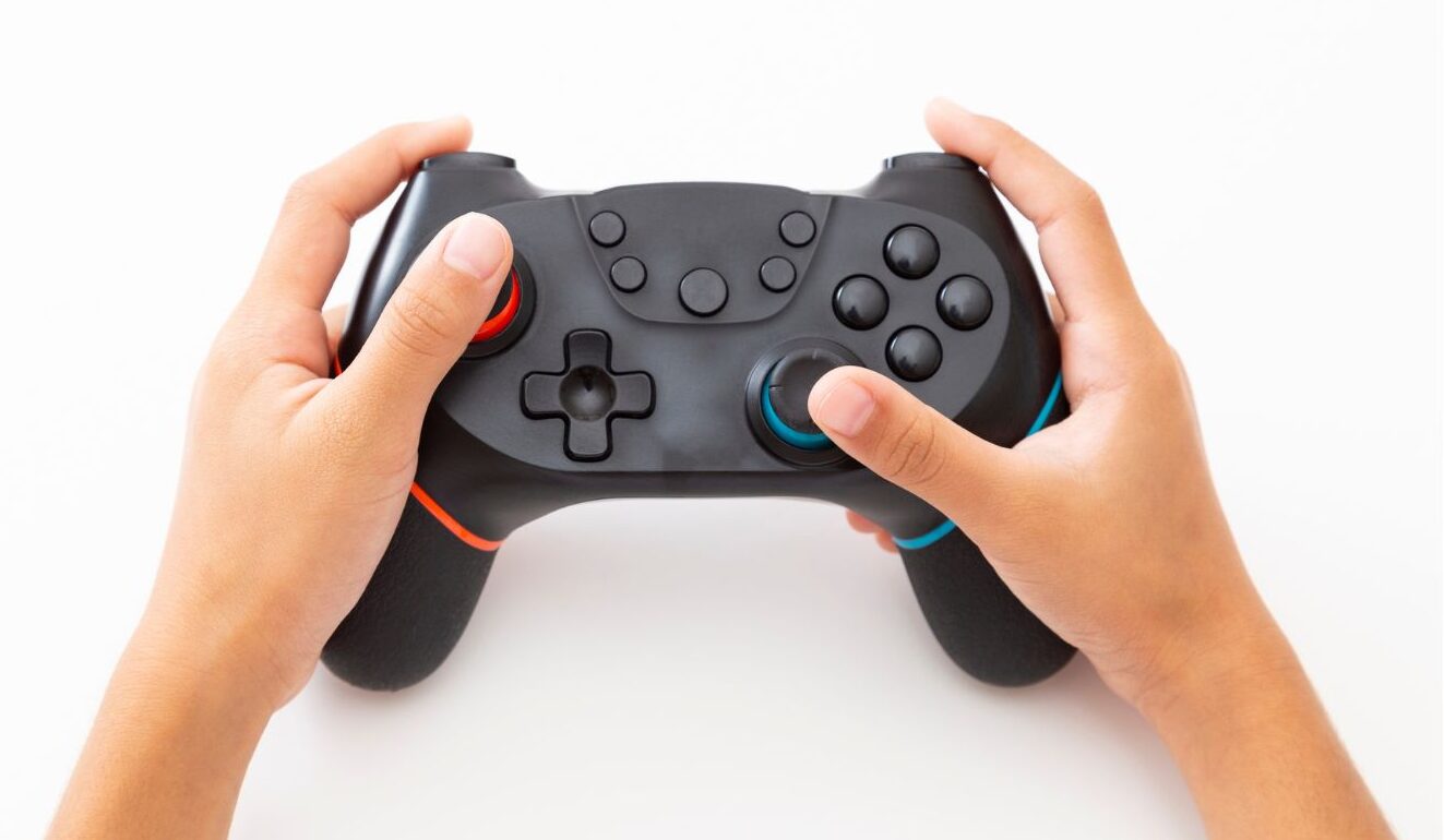 Mani che tengono un controller, metafora del controllo e della gestione della conversazione durante una call in inglese.